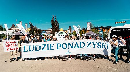 Climate campaigners in Poland are demanding a just transition from coal. Their banner reads “People over Profit.” 