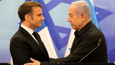 Israeli Prime Minister Benjamin Netanyahu, right, shakes hands with French President Emmanuel Macron after a joint press conference in Jerusalem, Tuesday, Oct. 24, 2023.