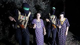 Yocheved Lifshitz, 85, center, and Nurit Cooper, 79, being escorted by Hamas