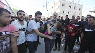 Палестинцы спасают выживших после израильского авиаудара по сектору Газа в Рафахе, среда, 25 октября 2023 года.
