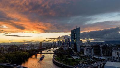 The sun sets over the buildings of the banking district and the European Central Bank, right, in Frankfurt, Germany, Friday, Oct. 20, 2023.