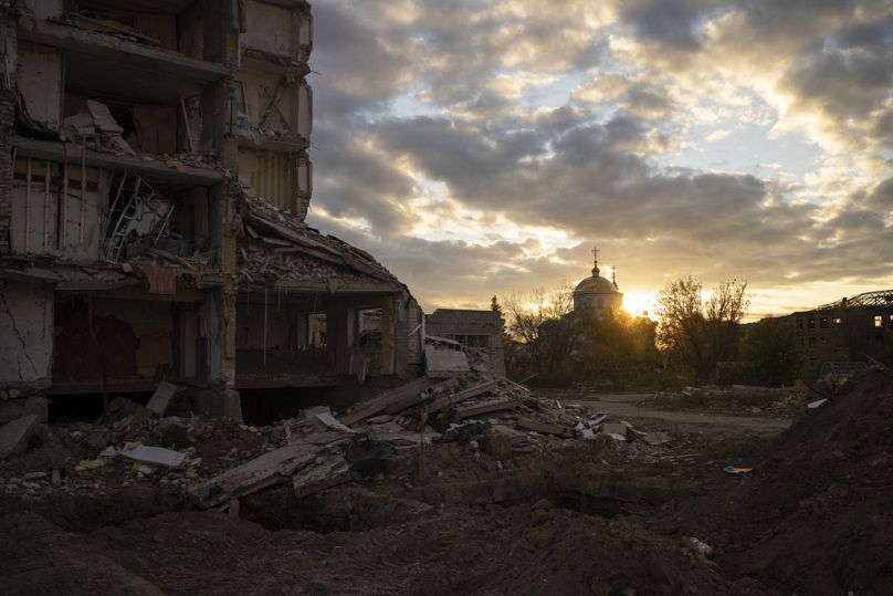 The sun sets over a destroyed building in Izyum, Ukraine, Tuesday, Oct. 24, 2023.