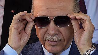 Turkish President Recep Tayyip Erdogan adjusts his sunglasses during a military parade in the Turkish occupied area of the divided capital Nicosia, Cyprus, Thursday, July 2023