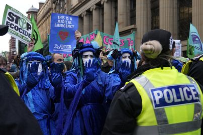 Extension Rebellion activists take part in a demonstration against 'Greenwashing' near the COP26 U.N. Climate Summit in Glasgow, Scotland, Wednesday, Nov. 3, 2021.