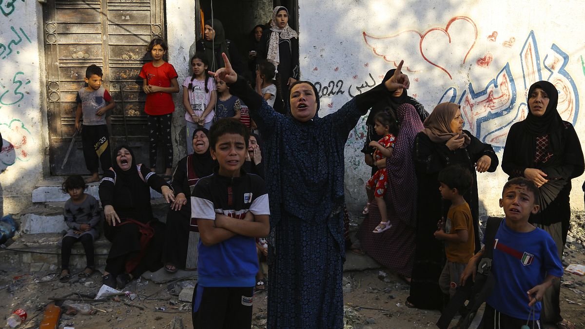 Palestinian women and children react following Israeli airstrikes targeting their neighbourhood in Gaza City, Saturday, Oct. 21, 2023. 