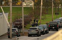 Law enforcement gather outside Schemengee's Bar and Grille, Thursday, Oct. 26, 2023, in Lewiston, Maine. 