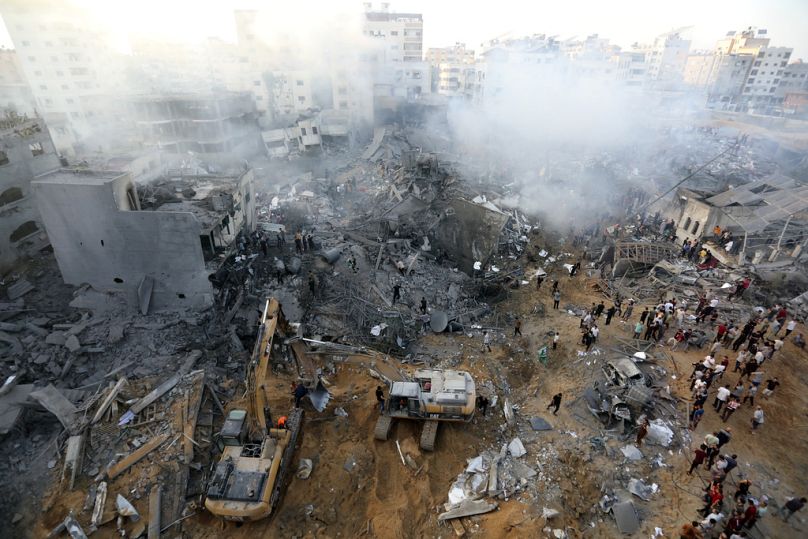 Palestinians inspect the damage of destroyed buildings following Israeli airstrikes on Gaza City, Wednesday, Oct. 25, 2023.
