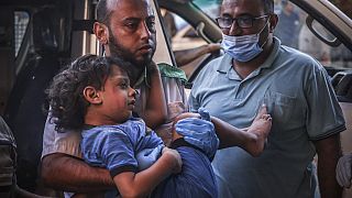Criança palestiniana é levada para o hospital após ataques aéreos de Israel ao campo de refugiados de Khan Yunis, na Faixa de Gaza