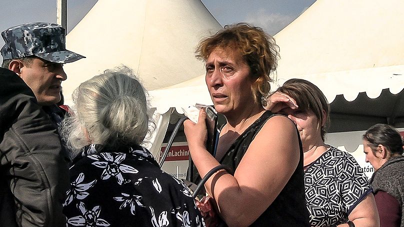 An Armenian woman cries as she and other refugees from the first group of about 30 people from Nagorno-Karabakh.