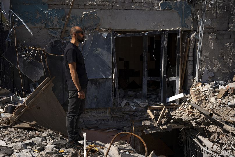 Ihnatenko stands beside a wide hole left from an Iskander missile that Russian forces used to strike a restaurant in June, killing 13, in Kramatorsk, Ukraine, 13 Sept 2023
