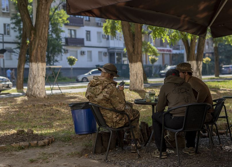 Ukrainian soldiers eat at a restaurant, in Kramatorsk, Ukraine, Wednesday, Sept. 13, 2023.