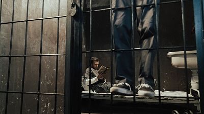 A prisoner reads a book