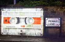 A mysterious cassette tape is being projected onto several "Beatles locations"