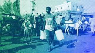 People gather to collect water in Khartoum, May 2023