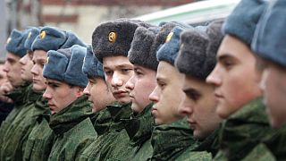 Russian military conscripts line up at a conscription point in Moscow, Friday, Nov. 26, 2010. 