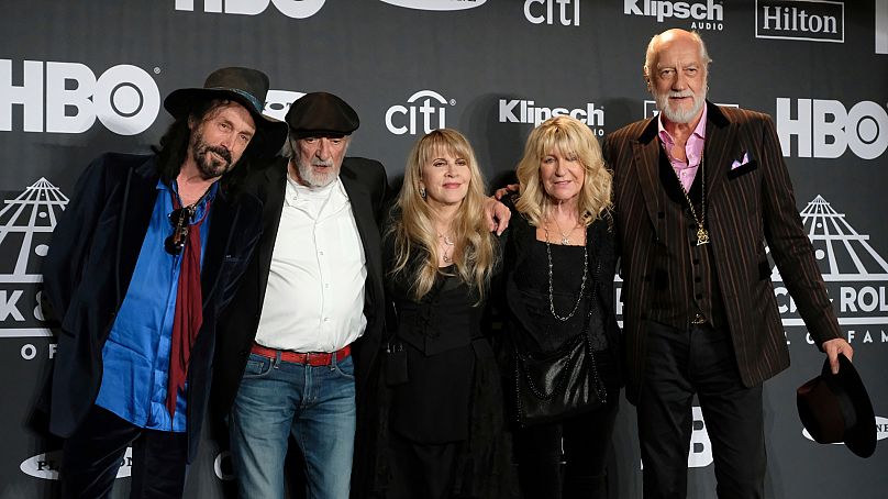 Stevie Nicks, center, poses with from left, Mike Campbell, John McVie, Christine McVie and Mick Fleetwood at the Rock & Roll Hall of Fame induction ceremony