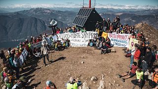 Activists stage a protest on top of Monte San Primo, 12 March 2023.  