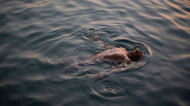 A man swims in Houhai Lake to beat the sweltering summer heat in Beijing. 2023 is virtually certain to be the hottest year in human history.