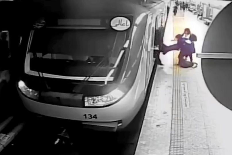 FILE - In this image from surveillance video aired by Iranian state TV, women pull 16-year-old Armita Geravand from a train car on the Tehran Metro, Oct. 1, 2023