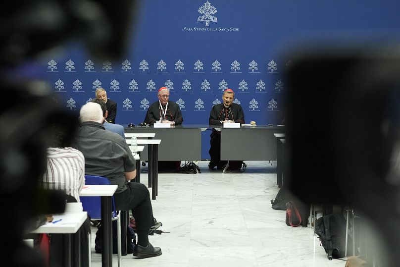 Cardinals Mario Grech, right, and Jean-Claude Hollerich talk to reporters during a press conference for the closing of the 16th general assembly of the synod of bishops