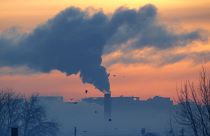 Smoke from a power plant is seen on a winter's morning during sunrise.
