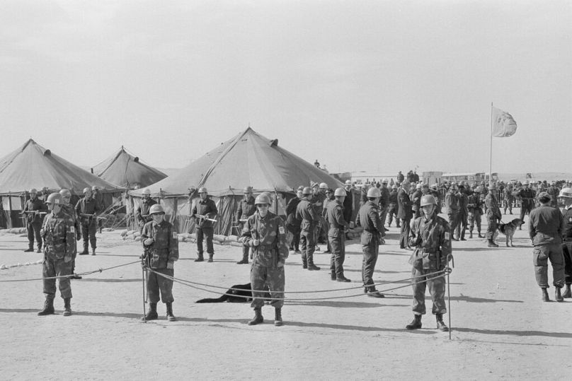 UN troops guard tents where Israeli and Egyptian chiefs of staff are meeting to discuss the separation of their respective forces during the Yom Kippur War, January 1974