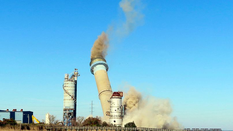 A fossil fuel-powered smoke stack is toppled to make space for renewables in New Jersey, USA