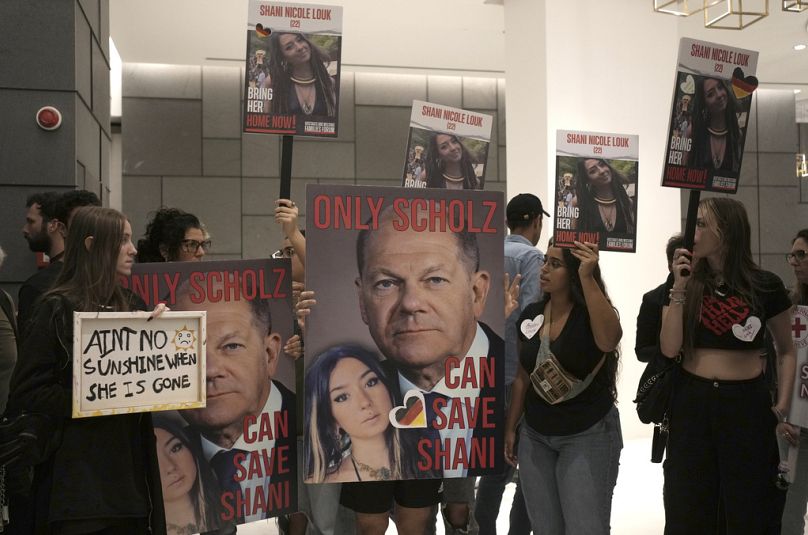 Supporters of missing Israeli Shani Louk hold placards calling for German Chancellor Olaf Scholz to help with her return, Tuesday Oct. 17, 2023.