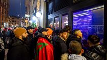 Football fans follow the World Cup quarterfinals outside a bar in Porta Venezia, Milan, Italy, 10 December 2022. 