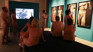 Guide Edgard Mestre talks to residents as they take part in a nudist visit to the Archaeology Museum of Catalonia, Barcelona, Spain, 28 October, 2023.