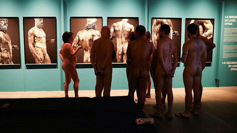 Members of the Catalan Naturism Club admire Luigi Spina's photographs of naked warriors from the 5th century BC, Barcelona, Spain, 28 October 2023.