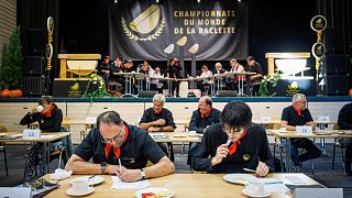 Members of the jury sample and grade raclettes during the contest in Morgins.