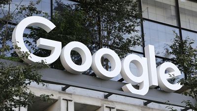 A Google sign hangs over an entrance to the company's new building, Sept. 6, 2023, in New York