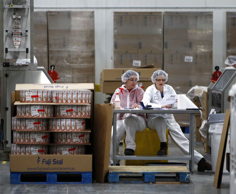 Two employees work in the sleeving plant where labels are put on containers at Chobani Greek Yogurt in South Edmeston, January 2012