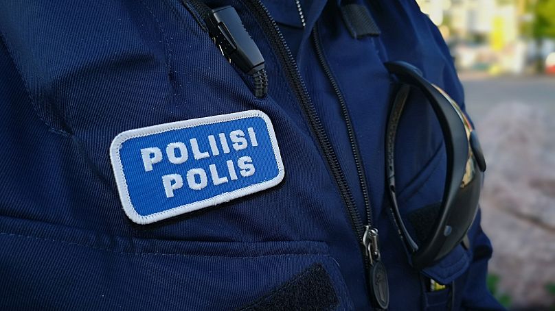 FILE: Close of detail on Finnish police officer's uniform