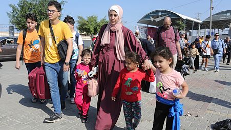 Palestinians cross to the Egyptian side of the border crossing with the Gaza Strip in Rafah Wednesday, Nov. 1, 2023.