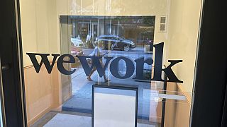 A sign for WeWork is displayed at the workspace-sharing office in the borough of Manhattan in New York, Aug. 9, 2023.