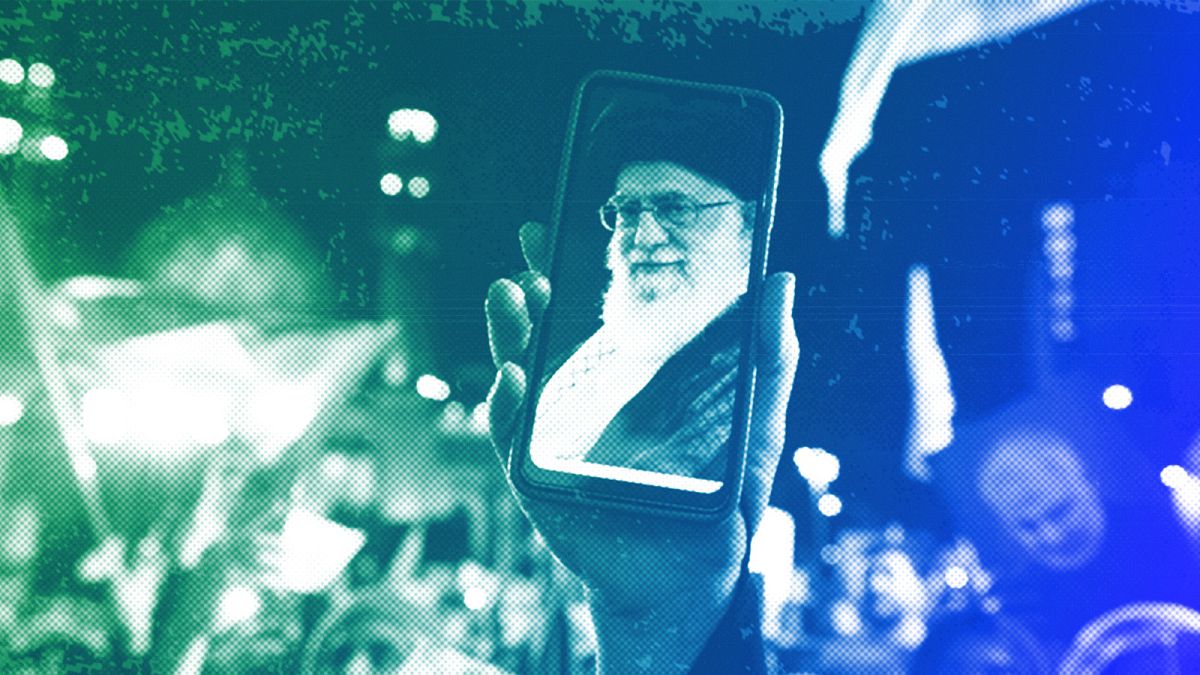 An Iranian demonstrator shows a photos of the Supreme Leader Ayatollah Ali Khamenei on the screen of her cellphone in Tehran, October 2023