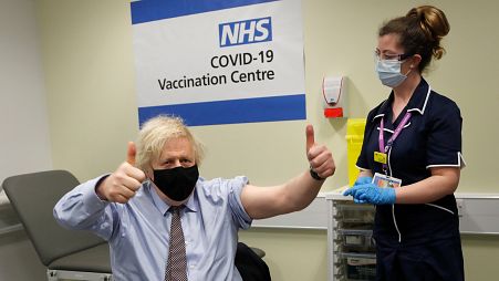 Boris Johnson gestures after receiving the first dose of the AstraZeneca Covid-19 vaccine at St.Thomas' Hospital in London, Friday, March 19, 2021.