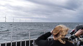 Guests tour the five turbines of America's first offshore wind farm, owned by the Danish company, Ørsted, off the coast of Block Island, R.I., on Oct. 17, 2022.