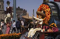 Visitors take photos of Day of the Dead themes presentations at Mexico City´s main square the Zocalo, Tuesday, Oct. 31, 2023.