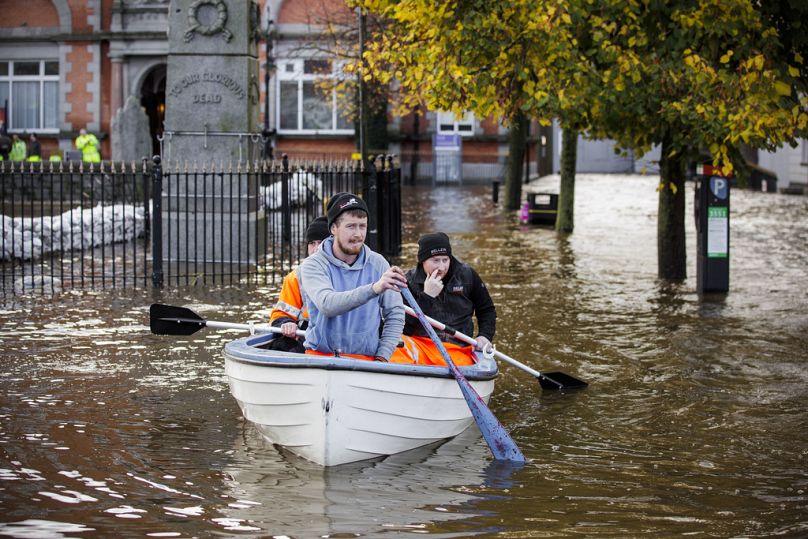 People canoe down a flooded Bank Parade in Newry Town, Co Down, Northern Ireland, Tuesday, Oct. 31, 2023.