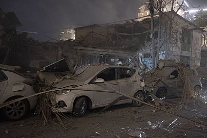 Cars and a building are destroyed after a rocket fired from Gaza hit Tel Aviv, in Israel, on 7 October 2023.