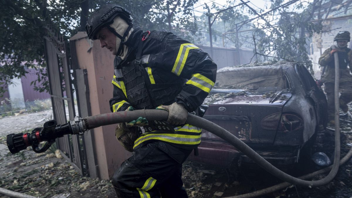 In this photo provided by the Ukrainian Emergency Service, emergency services personnel work to extinguish a fire in Kherson, Ukraine, on Monday, Oct. 30, 2023,