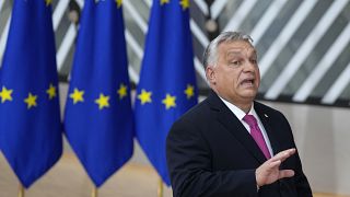 Hungary's Prime Minister Viktor Orban speaks with the media as he arrives for an EU summit at the European Council building in Brussels, Thursday, Oct. 26, 2023.