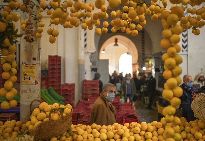 A man walks past a stall of lemons in the central market,in Tunis, January 2021