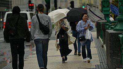 People shelter from the rain under their umbrellas, in San Sebastian, northern Spain, Thursday, Nov. 2, 2023.