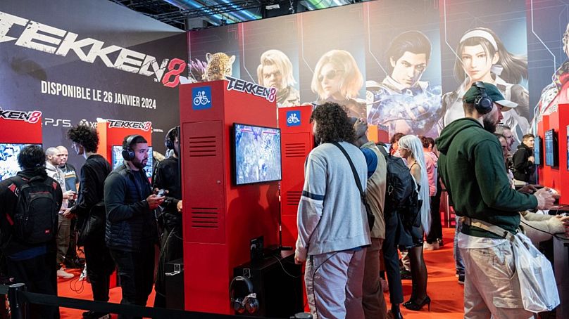Visitors play the "Tekken 8" video fighting game co-developed by Bandai Namco Studios and Arika