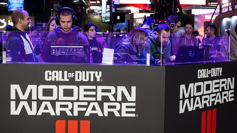 Visitors play the "Call of Duty: Modern Warfare" shooter video game developed by Infinity Ward and published by Activision