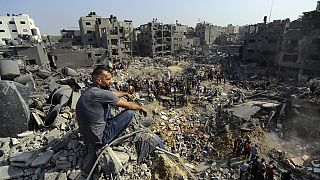 A man sits on the rubble overlooking the debris of buildings that were targeted by Israeli airstrikes in the Jabaliya refugee camp, northern Gaza Strip, November 1, 2023